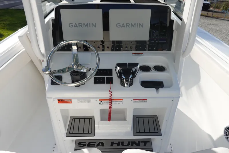 Slide: The Image of 2026 Sea Hunt Ultra 275 SE boat console with dual Garmin displays and steering wheel. - 15