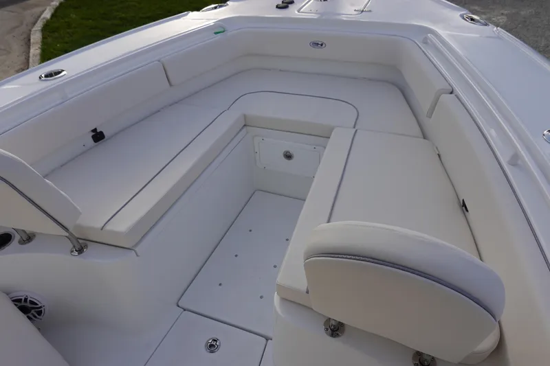 Slide: The Image of 2026 Sea Hunt Ultra 275 SE boat interior with white cushioned seating. - 22