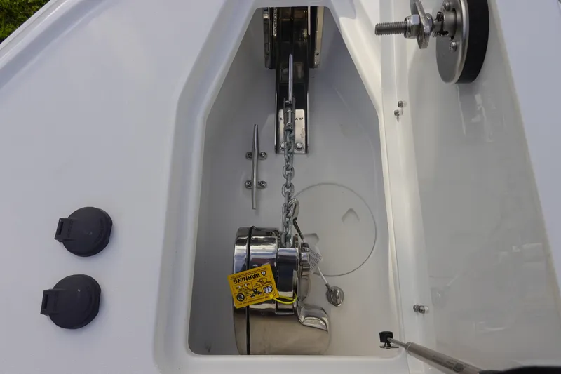 Slide: The Image of Anchor compartment of 2026 Sea Hunt Ultra 275 SE boat, featuring chain and winch system. - 27