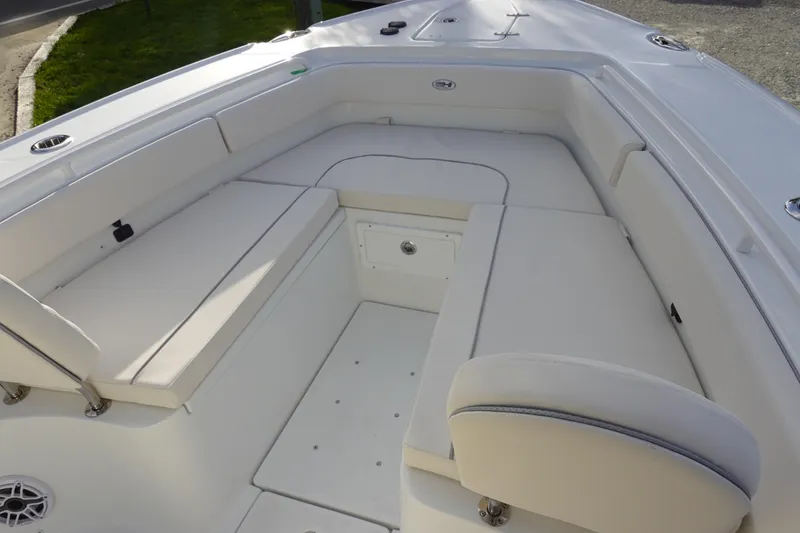 Slide: The Image of 2026 Sea Hunt Ultra 275 SE boat interior with cushioned seating and storage. - 29