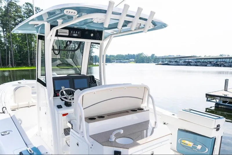 Slide: The Image of 2026 Sea Hunt Ultra 275 SE with twin 250 V6 outboard engines, parked outdoors. - 4