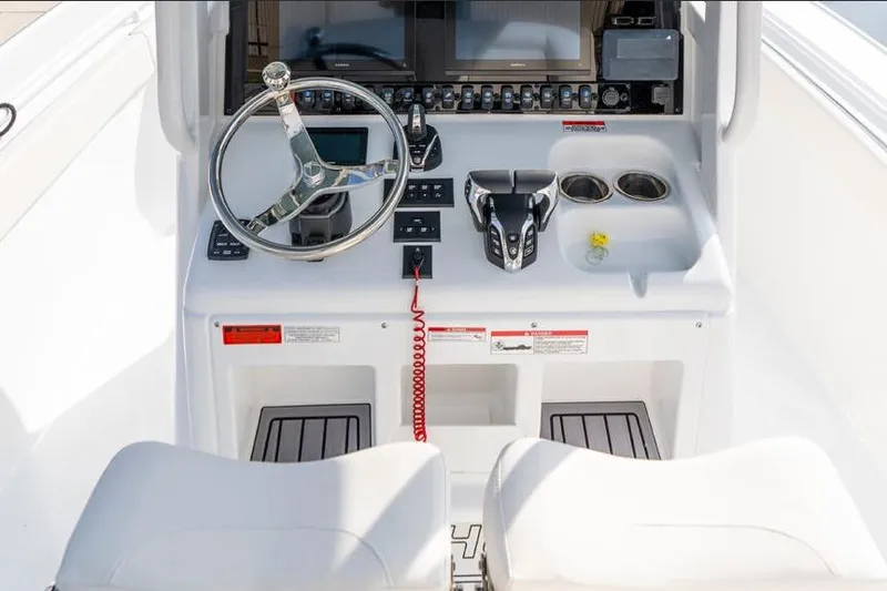 Slide: The Image of 2026 Sea Hunt Ultra 275 SE boat with white cushioned seating and dual engines. - 5