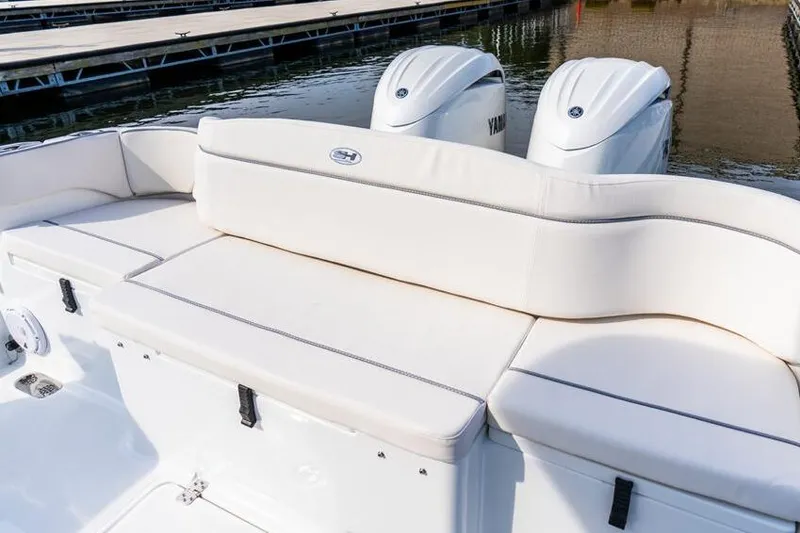 Slide: The Image of 2026 Sea Hunt Ultra 275 SE boat with open storage compartments and seating area. - 7