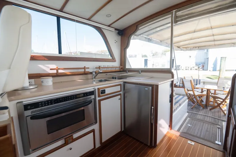 Slide: The Image of Interior of 2005 Mast & Mallet Thomas Point boat with kitchen and seating area. - 10