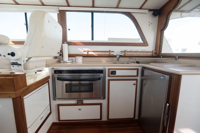 Slide: The Image of Interior of 2005 Mast & Mallet Thomas Point boat with kitchen and seating area. - 11