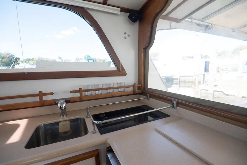 Slide: The Image of Interior of 2005 Mast & Mallet Thomas Point boat, featuring a modern kitchen area. - 14