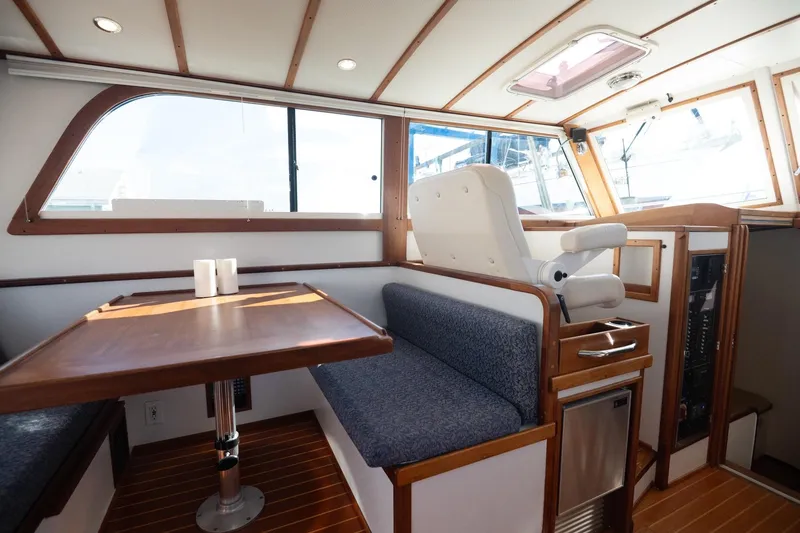 Slide: The Image of Interior of 2005 Mast & Mallet Thomas Point boat with seating and wooden table. - 16