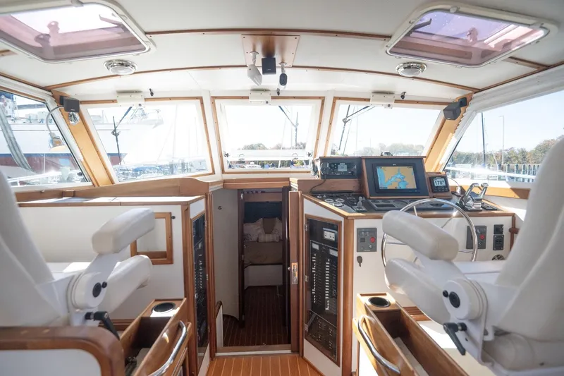 Slide: The Image of 2005 Mast & Mallet Thomas Point boat interior with navigation equipment and steering wheel. - 20