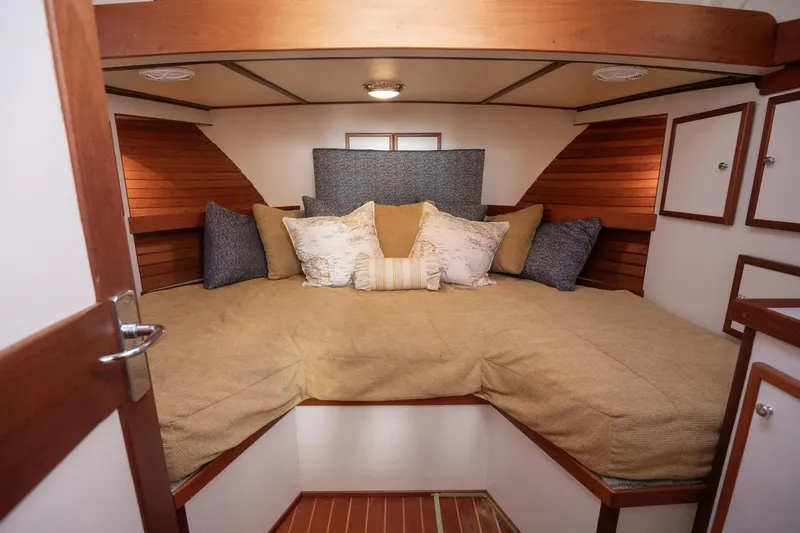 Slide: The Image of Cozy cabin interior of 2005 Mast & Mallet Thomas Point boat with plush bedding. - 23