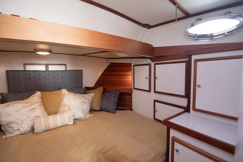 Slide: The Image of Cozy cabin interior of 2005 Mast & Mallet Thomas Point boat with plush bedding. - 24