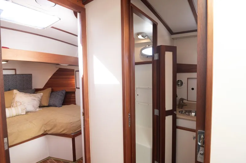 Slide: The Image of Interior of 2005 Mast & Mallet Thomas Point boat, featuring cozy cabin and compact bathroom. - 28