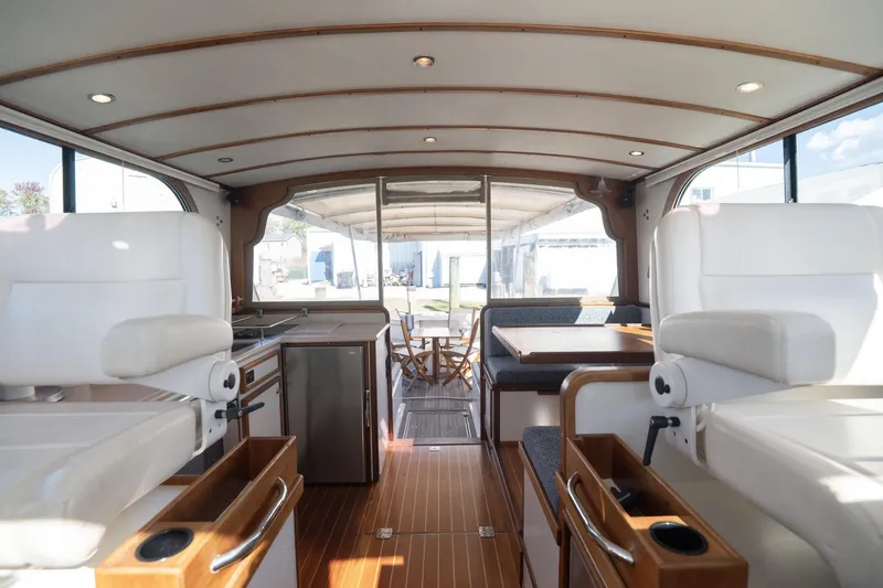 Slide: The Image of Interior of 2005 Mast & Mallet Thomas Point boat, featuring seating and wooden flooring. - 30