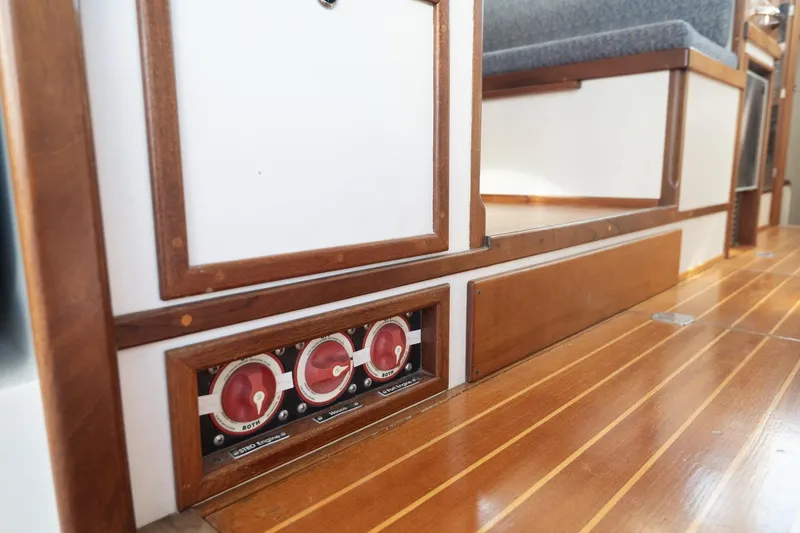 Slide: The Image of Interior of 2005 Mast & Mallet Thomas Point boat, featuring wooden paneling and control switches. - 35