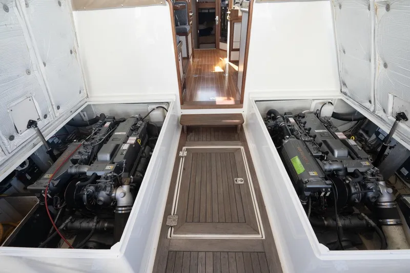 Slide: The Image of Engine room of 2005 Mast & Mallet Thomas Point boat, showcasing dual engines and wooden flooring. - 39