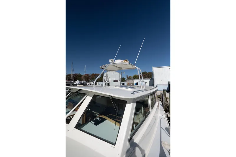 Slide: The Image of 2005 Mast & Mallet Thomas Point boat with antennas, docked under clear blue sky. - 48