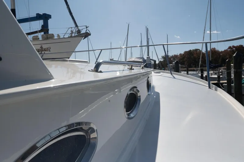 Slide: The Image of 2005 Mast & Mallet Thomas Point boat deck with portholes, docked at marina. - 49