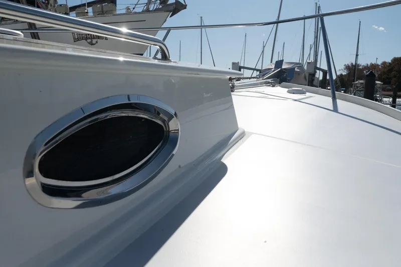 Slide: The Image of 2005 Mast & Mallet Thomas Point boat deck with chrome details in marina setting. - 50