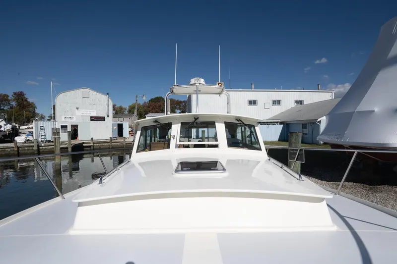 Slide: The Image of 2005 Mast & Mallet Thomas Point boat docked at a marina under clear blue skies. - 51