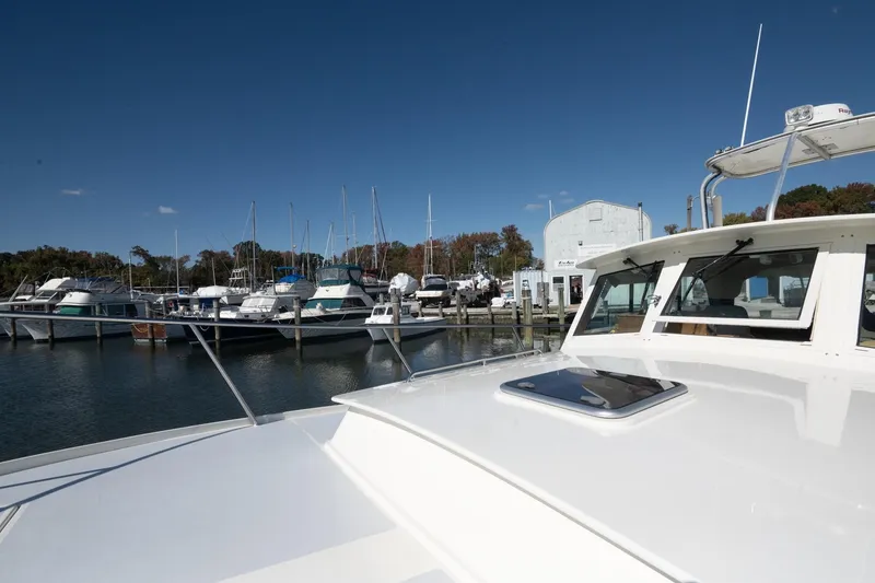 Slide: The Image of 2005 Mast & Mallet Thomas Point boat docked at a marina under clear blue skies. - 53