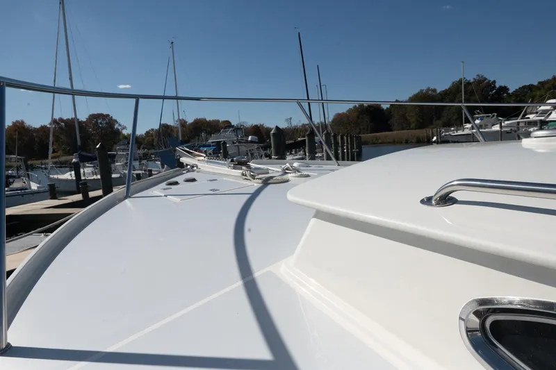 Slide: The Image of 2005 Mast & Mallet Thomas Point boat docked at marina under clear blue sky. - 54