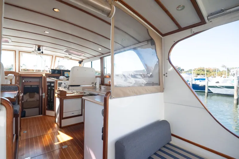 Slide: The Image of Interior of 2005 Mast & Mallet Thomas Point boat with wooden accents and seating. - 9