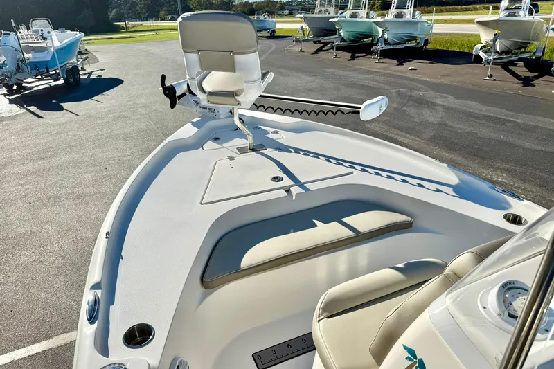 Slide: The Image of 2023 Key West 188 Bay Reef boat with seating and trolling motor in a marina. - 12
