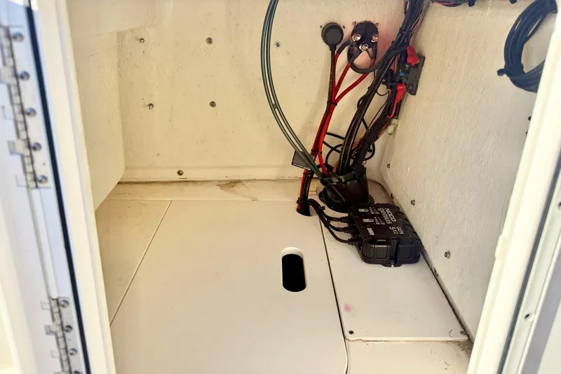 Slide: The Image of 2023 Key West 188 Bay Reef boat compartment with wiring and battery setup. - 25