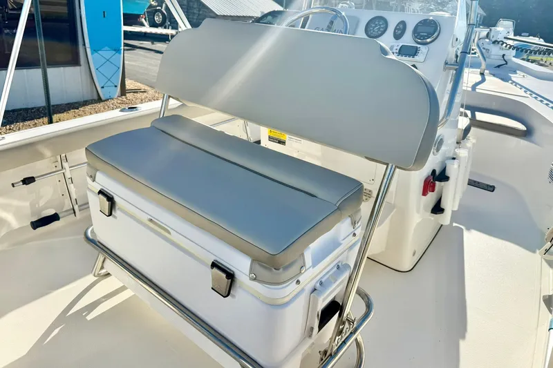 Slide: The Image of 2023 Key West 188 Bay Reef boat interior with cushioned seating and control panel. - 27