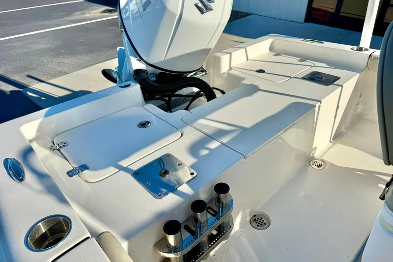 Slide: The Image of 2023 Key West 188 Bay Reef boat interior with storage compartments and rod holders. - 29