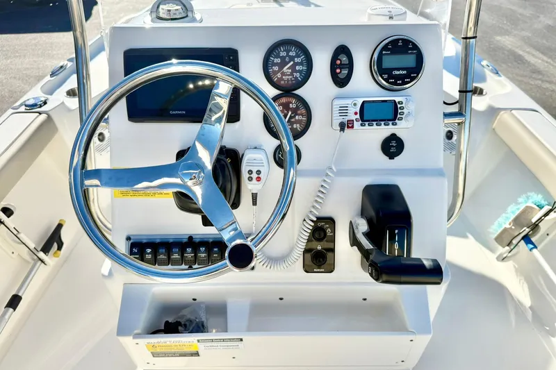 Slide: The Image of 2023 Key West 188 Bay Reef boat dashboard with steering wheel and navigation controls. - 3