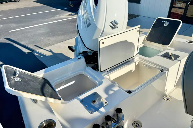 Slide: The Image of 2023 Key West 188 Bay Reef boat with open storage compartments and Suzuki engine. - 30