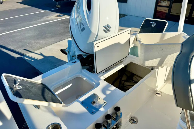 Slide: The Image of 2023 Key West 188 Bay Reef boat interior with open storage compartments and engine view. - 31