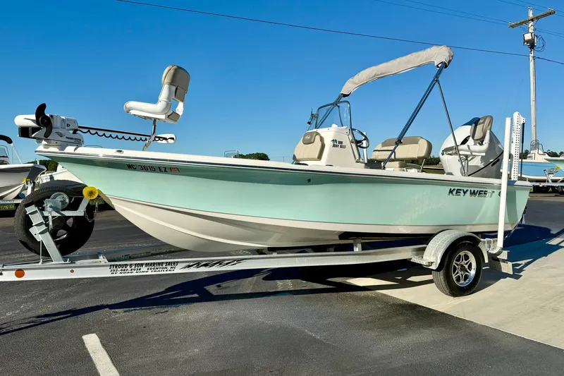 Slide: The Image of 2023 Key West 188 Bay Reef boat on trailer, light blue hull, parked outdoors. - 5
