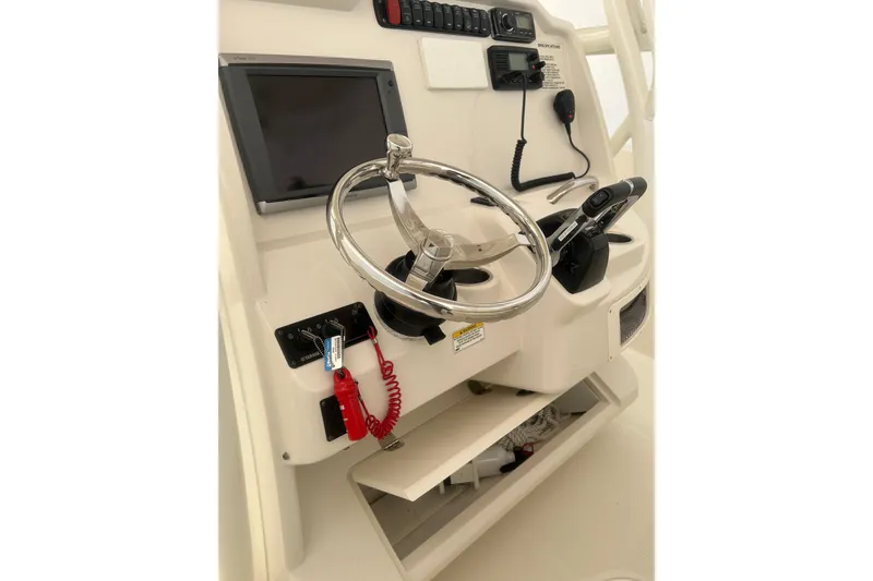 Slide: The Image of 2015 Sailfish 290 CC boat docked at sunset on a calm lake. - 1