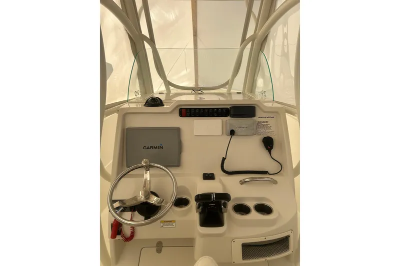 Slide: The Image of 2015 Sailfish 290 CC boat interior with storage compartments and seating. - 10