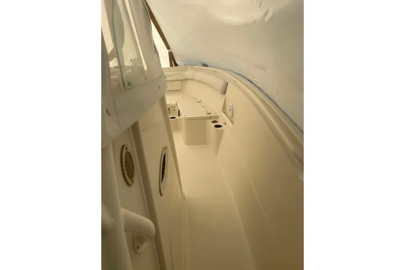 Slide: The Image of 2015 Sailfish 290 CC boat interior, featuring spacious seating and sleek design. - 13
