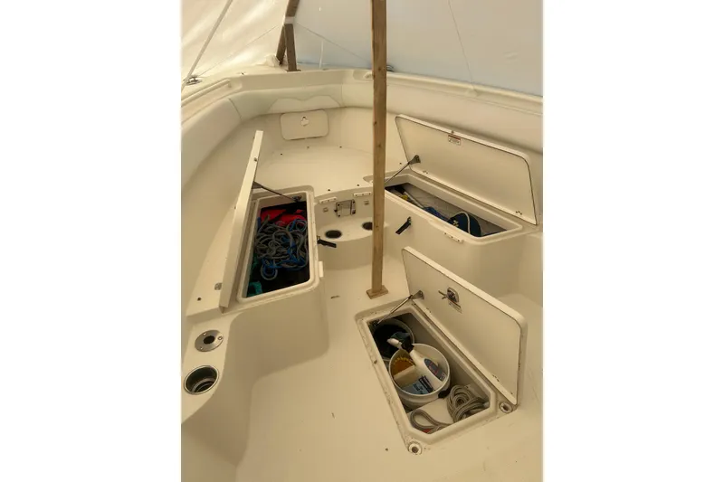 Slide: The Image of 2015 Sailfish 290 CC boat interior with seating and storage compartments. - 20