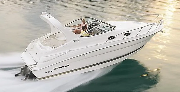 The Image of 2001 Wellcraft 2800 Martinique boat docked at a marina under a partly cloudy sky. - 0