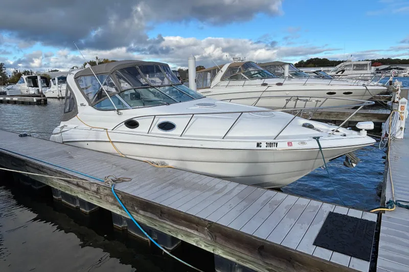 Slide: The Image of 2001 Wellcraft 2800 Martinique boat cockpit with steering wheel and control panel. - 2