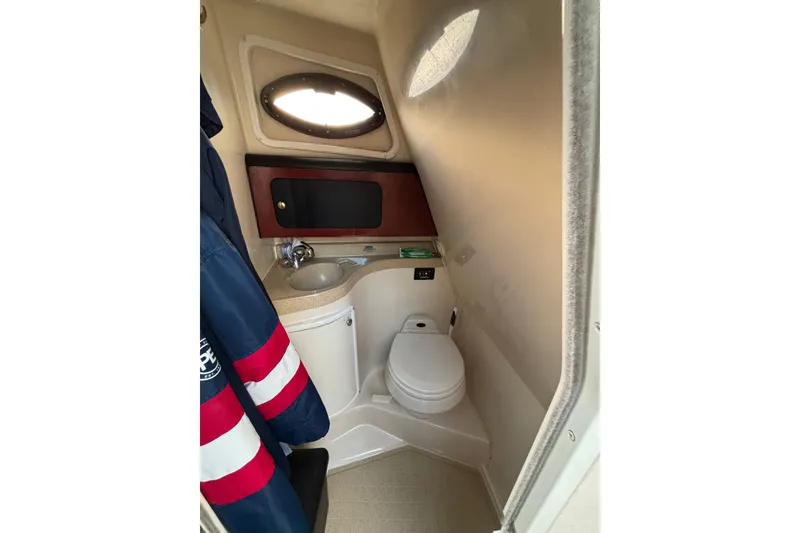 Slide: The Image of Interior cabin of 2001 Wellcraft 2800 Martinique boat with cozy bedding and curtains. - 22