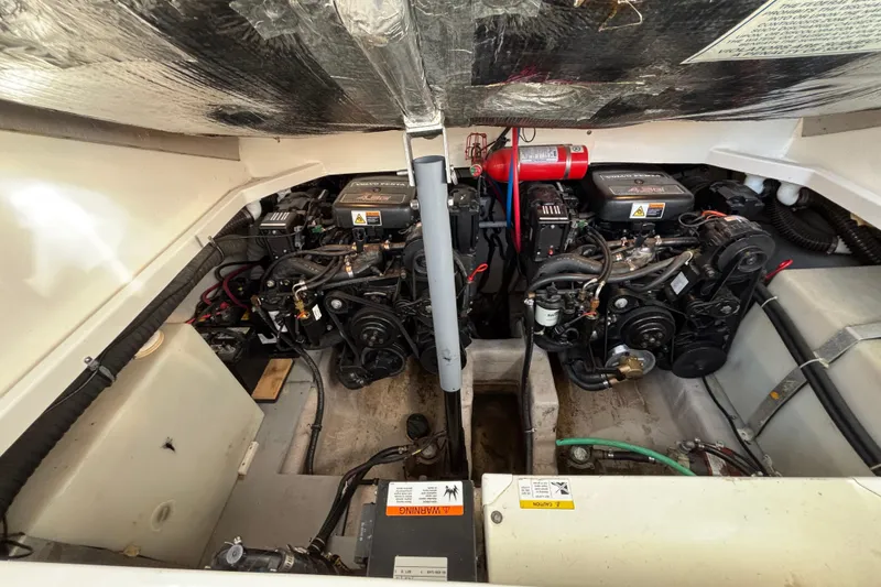 Slide: The Image of Engine compartment of a 2001 Wellcraft 2800 Martinique boat, showcasing dual engines. - 24