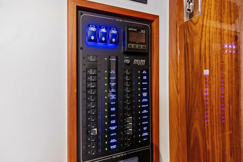 Slide: The Image of Electrical control panel on 2025 MJM 35 boat, featuring switches and indicators. - 12