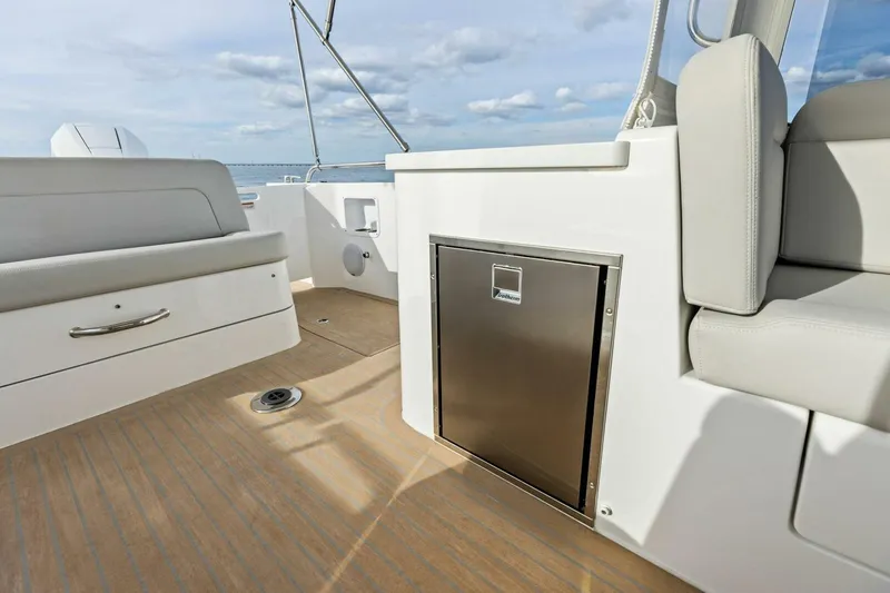 Slide: The Image of 2025 MJM 35 boat interior with seating and stainless steel storage. - 23