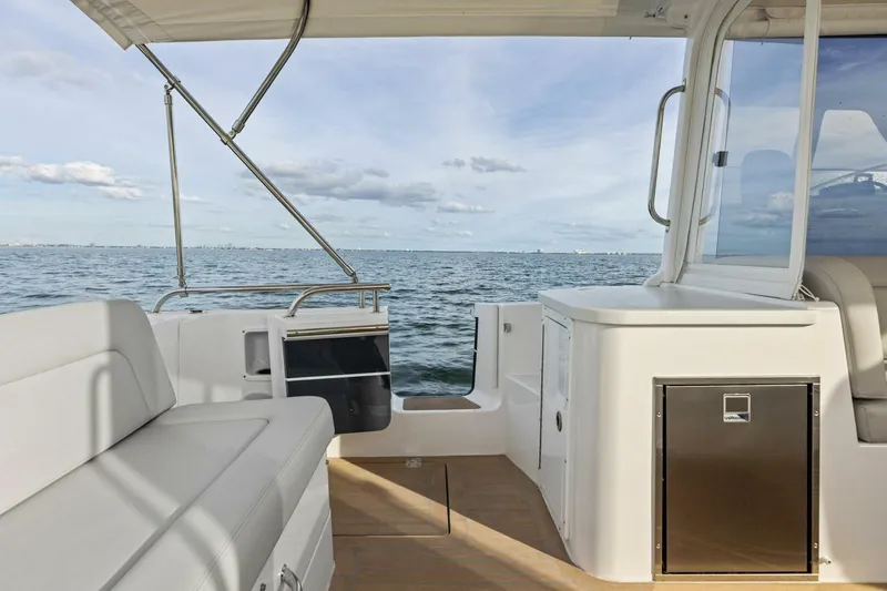 Slide: The Image of 2025 MJM 35 boat interior with seating, ocean view, and clear skies. - 27