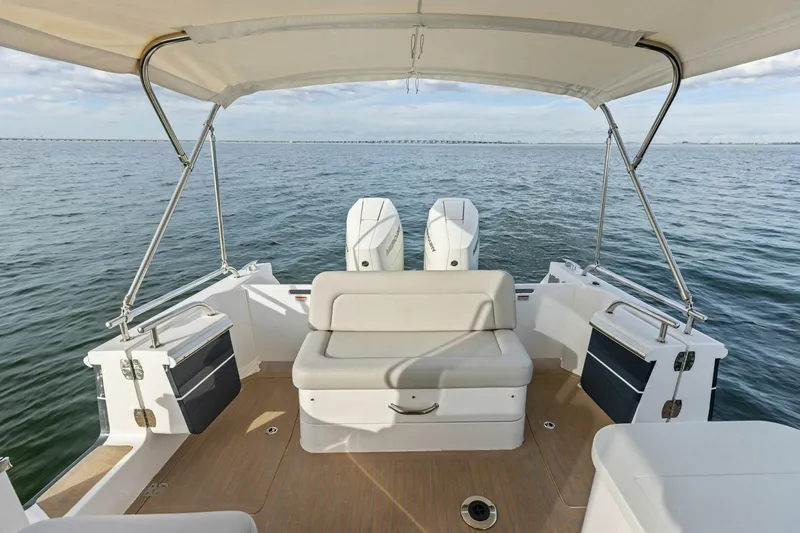 Slide: The Image of 2025 MJM 35 boat interior with seating, canopy, and ocean view. - 28