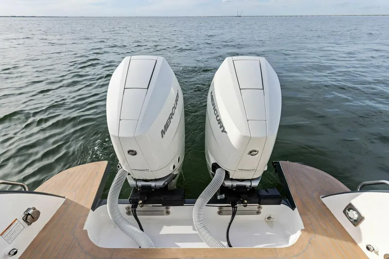 Slide: The Image of Twin Mercury outboard engines on 2025 MJM 35 boat, cruising on open water. - 29