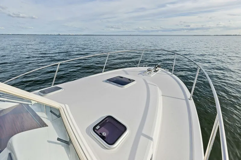 Slide: The Image of Bow view of 2025 MJM 35 yacht on calm waters under a cloudy sky. - 36