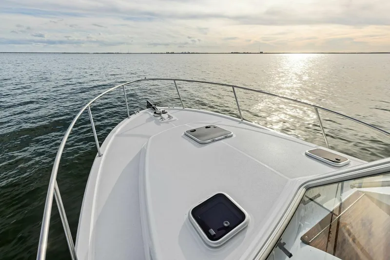 Slide: The Image of Bow view of 2025 MJM 35 yacht on calm water at sunset. - 37