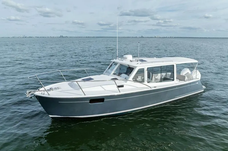 Slide: The Image of 2025 MJM 35 boat cruising on open water under a cloudy sky. - 41