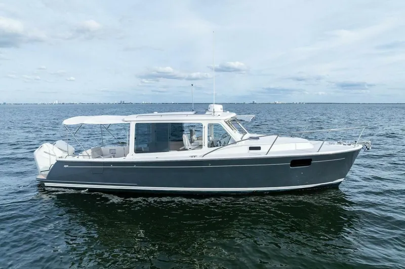 Slide: The Image of 2025 MJM 35 boat on calm ocean waters under a cloudy sky. - 44